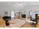 Bright, spacious bedroom featuring vaulted ceilings, soft natural light, and convenient ensuite bathroom access at 180 Normandy Rd, Louisburg, NC 27549
