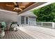 Spacious back deck featuring wood ceiling, fan, and grill ready for outdoor entertaining and relaxation at 180 Normandy Rd, Louisburg, NC 27549