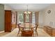 Dining room featuring a wooden table, chairs, a chandelier, and views of the backyard at 180 Normandy Rd, Louisburg, NC 27549