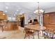 Open concept dining area with a round table, chairs, chandelier, and bar seating at 180 Normandy Rd, Louisburg, NC 27549