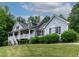 Charming two-story home with a welcoming front porch and manicured landscaping at 180 Normandy Rd, Louisburg, NC 27549