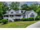 Inviting two-story home featuring a spacious front porch perfect for relaxing at 180 Normandy Rd, Louisburg, NC 27549