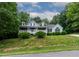 Beautifully landscaped home with a classic design and an inviting front porch at 180 Normandy Rd, Louisburg, NC 27549