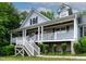 The cozy covered front porch is an ideal place to unwind and enjoy the surrounding nature at 180 Normandy Rd, Louisburg, NC 27549