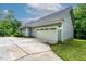 Attached garage and paved driveway enhance the functionality and curb appeal of the property at 180 Normandy Rd, Louisburg, NC 27549