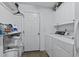 Clean and efficient laundry room with white cabinets and appliances at 180 Normandy Rd, Louisburg, NC 27549