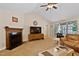 Cozy living room with fireplace and large windows, creating a bright and welcoming atmosphere at 180 Normandy Rd, Louisburg, NC 27549