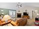 Warm and inviting living room featuring a fireplace, ample seating, and plenty of natural light at 180 Normandy Rd, Louisburg, NC 27549