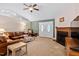 Inviting living room with fireplace, plush seating, and abundant natural light, perfect for relaxation and gatherings at 180 Normandy Rd, Louisburg, NC 27549
