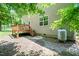 Back exterior view with wooden deck, stairs to the yard, and a propane tank at 1826 Fillmore Dr, Creedmoor, NC 27522