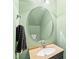 Cozy bathroom with a granite vanity, chrome fixtures, and a round mirror at 1826 Fillmore Dr, Creedmoor, NC 27522