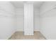 Spacious walk-in closet featuring ample shelving and carpeting at 1826 Fillmore Dr, Creedmoor, NC 27522