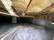 A crawl space featuring a vapor barrier, beams, and a plumbing system at 1826 Fillmore Dr, Creedmoor, NC 27522
