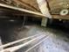 Crawl space featuring concrete supports, piping, and a vapor barrier for moisture control at 1826 Fillmore Dr, Creedmoor, NC 27522