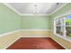 Bright dining room featuring hardwood floors, a chandelier, and a large window at 1826 Fillmore Dr, Creedmoor, NC 27522