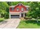 Charming two-story home with a red and beige facade, a two-car garage, and a well-manicured front yard at 1826 Fillmore Dr, Creedmoor, NC 27522