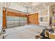 Spacious garage with high ceilings, open framework, and natural light from the closed garage door at 1826 Fillmore Dr, Creedmoor, NC 27522