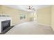 View of open living room with fireplace, ceiling fan, and access to deck at 1826 Fillmore Dr, Creedmoor, NC 27522