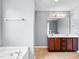 Bright main bathroom with double vanity and soaking tub at 1826 Fillmore Dr, Creedmoor, NC 27522