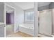 Well-lit bathroom with soaking tub and glass door shower at 1826 Fillmore Dr, Creedmoor, NC 27522