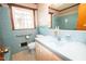 Bathroom with blue tiling, bathtub, toilet and sink with vintage design at 205 N Augusta Ave, Benson, NC 27504