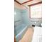 Bathroom with blue tiling, bathtub, toilet and sink with vintage design at 205 N Augusta Ave, Benson, NC 27504