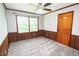Cozy bedroom featuring natural light, soft carpeting, and classic wood trim at 205 N Augusta Ave, Benson, NC 27504