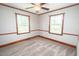 Cozy bedroom featuring natural light, soft carpeting, and classic wood trim at 205 N Augusta Ave, Benson, NC 27504