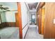 Hallway featuring recent carpet and showing access to the main bedroom at 205 N Augusta Ave, Benson, NC 27504