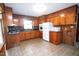 Functional kitchen with wood cabinetry, complemented by a retro tile flooring at 205 N Augusta Ave, Benson, NC 27504