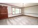 Inviting living room featuring soft carpeting, large windows, and modern lighting at 205 N Augusta Ave, Benson, NC 27504