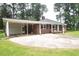 Spacious driveway and carport of a brick home, providing ample parking and covered space at 205 N Augusta Ave, Benson, NC 27504