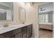 Bathroom featuring double sinks, a vanity, and an open view to the bedroom at 208 Jones Hill Rd, Holly Springs, NC 27540