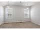 Bright bedroom featuring neutral walls, carpet, and two large windows that provide ample natural light at 208 Jones Hill Rd, Holly Springs, NC 27540