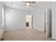 This spacious bedroom includes neutral carpet, ceiling fan and a view of an adjacent bathroom at 208 Jones Hill Rd, Holly Springs, NC 27540