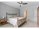 Comfortable bedroom with ceiling fan, neutral colors, paneled accent wall and bedside table at 208 Jones Hill Rd, Holly Springs, NC 27540
