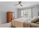 Serene bedroom featuring plantation shutters, a ceiling fan, and a wooden dresser at 208 Jones Hill Rd, Holly Springs, NC 27540