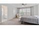 Bright bedroom boasts neutral decor, large windows, a ceiling fan, and an adjacent bathroom at 208 Jones Hill Rd, Holly Springs, NC 27540
