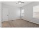 Spacious bedroom with neutral carpet, ceiling fan, two large windows, and bright white walls at 208 Jones Hill Rd, Holly Springs, NC 27540