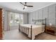 Cozy bedroom with neutral tones, a ceiling fan, paneled accent wall and lots of natural light at 208 Jones Hill Rd, Holly Springs, NC 27540