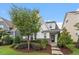 A charming home with white siding, red brick facade, professional landscaping and inviting front entrance at 208 Jones Hill Rd, Holly Springs, NC 27540