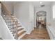 Elegant foyer featuring hardwood floors, staircase with iron railings and entry to living area at 208 Jones Hill Rd, Holly Springs, NC 27540