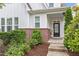 Inviting front entry with brick facade, craftsman-style door, and manicured landscaping at 208 Jones Hill Rd, Holly Springs, NC 27540