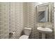 Stylish half bath with unique wallpaper, pedestal sink, and modern fixtures at 208 Jones Hill Rd, Holly Springs, NC 27540