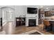 Open-concept living area with fireplace, shelving, and view into the kitchen at 208 Jones Hill Rd, Holly Springs, NC 27540