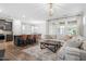 Open-concept living room with hardwood floors, a cozy sofa, and ample natural light at 208 Jones Hill Rd, Holly Springs, NC 27540