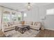 Bright living room featuring a neutral palette, plush seating, and large windows at 208 Jones Hill Rd, Holly Springs, NC 27540