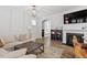 Cozy living room with fireplace, built-in shelves, and comfortable sofa seating at 208 Jones Hill Rd, Holly Springs, NC 27540