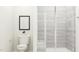 Clean bathroom featuring a toilet, minimalist artwork, and tiled walk-in shower at 215 Carova Bnd, Apex, NC 27539