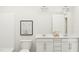 Bright bathroom featuring a double vanity with white cabinets and contemporary decor at 215 Carova Bnd, Apex, NC 27539